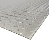 Diamond plate metal sheet on a white background