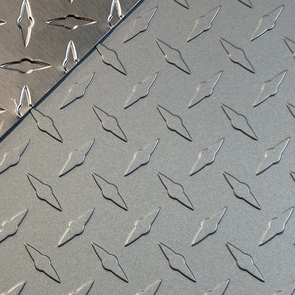 Close-up view of a frost silver aluminum diamond plate embossed sheet.